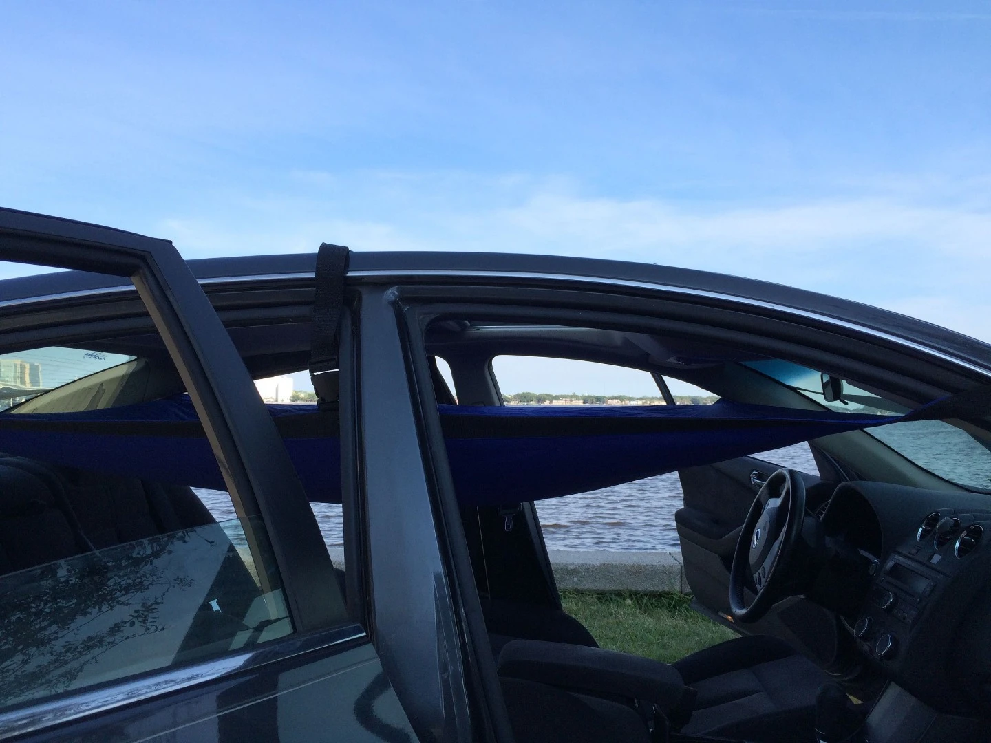 The Car Hammock straps run out the doors and around the windshield, rear window and roof