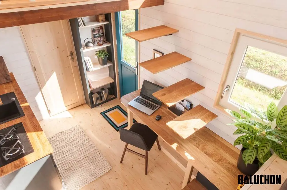 To reach the main bedroom, the owners must first climb atop the desk and then use the stairs