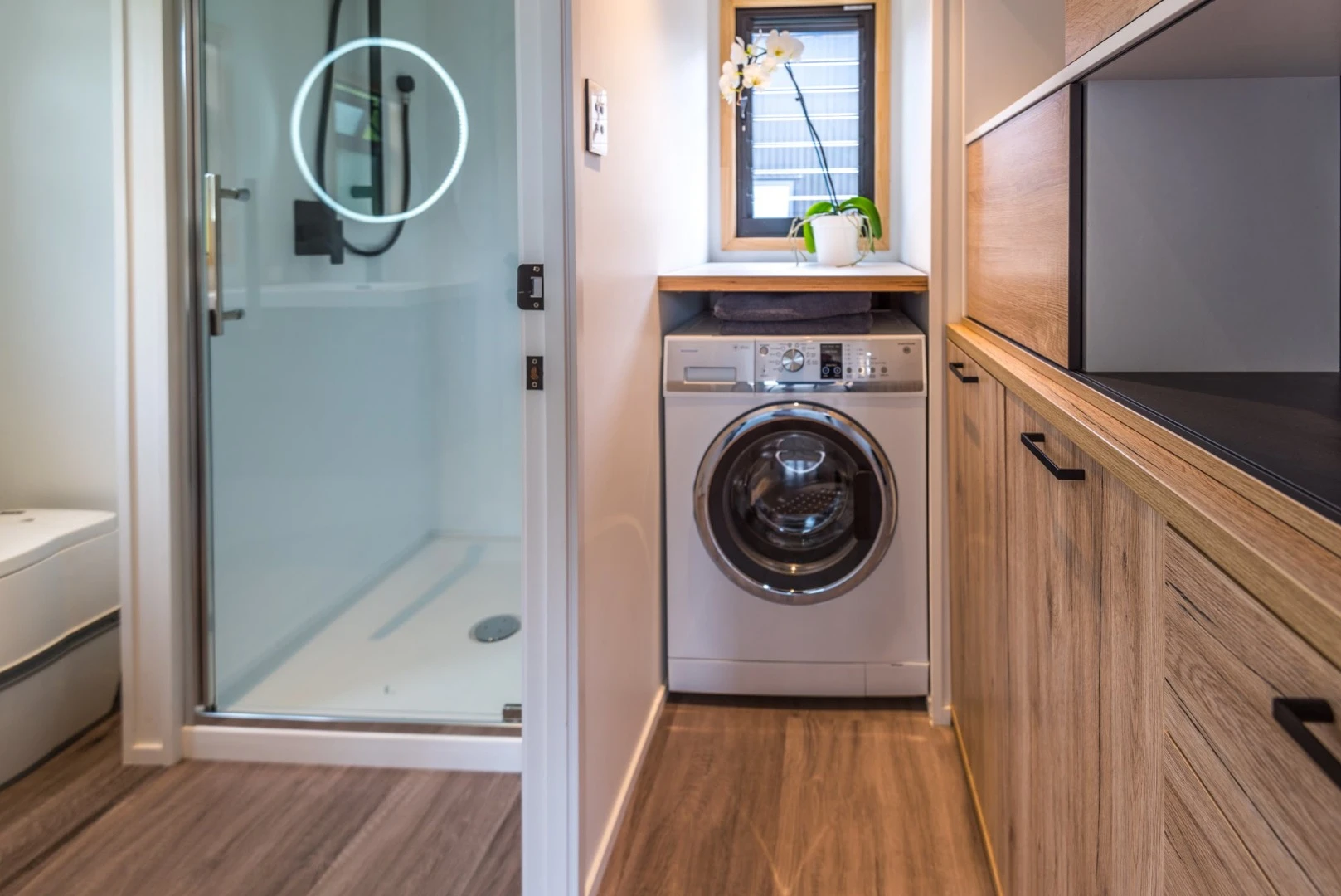 The laundry sits neatly next to the full bathroom