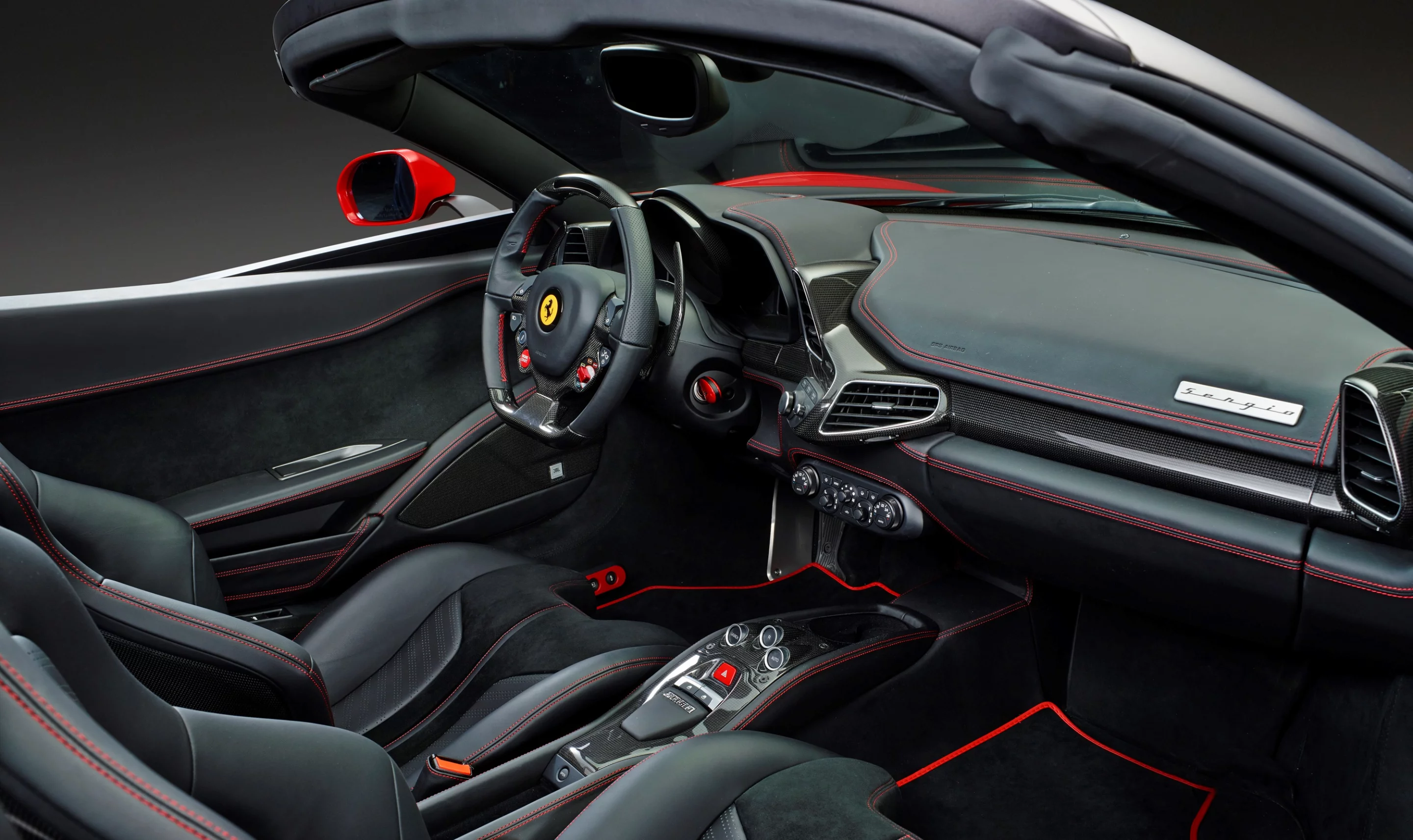 The first Sergio has black leather upholstery with contrast red stitching