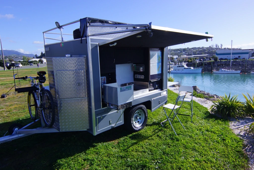 The kitchen includes a refrigerator, dual-burner stove and sink