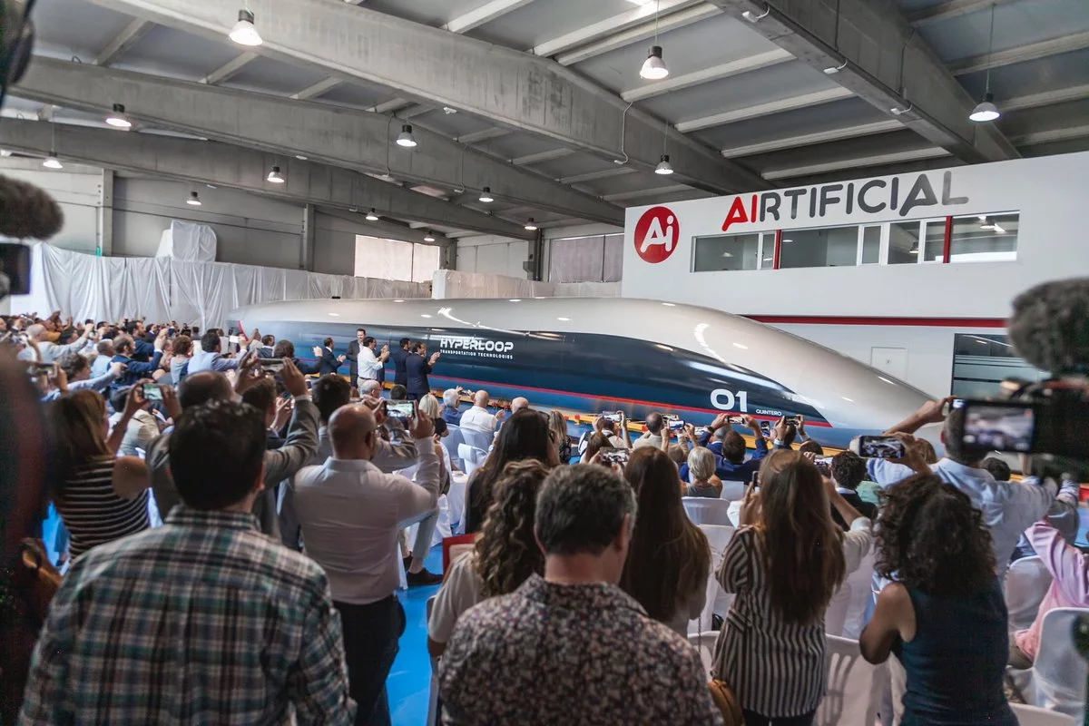 Attendees watch on as HyperloopTT unveils its passenger pod in Spain