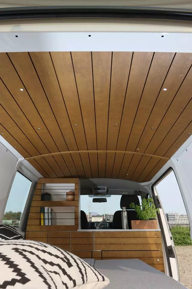 Many van converters integrate the driver area seats into the camper design, but Bullifaktur splits them off with its full-width front kitchen