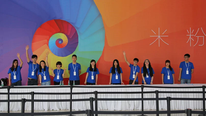 Hey, what are those Apple geniuses doing at the Xiaomi event? Oh, wait ...