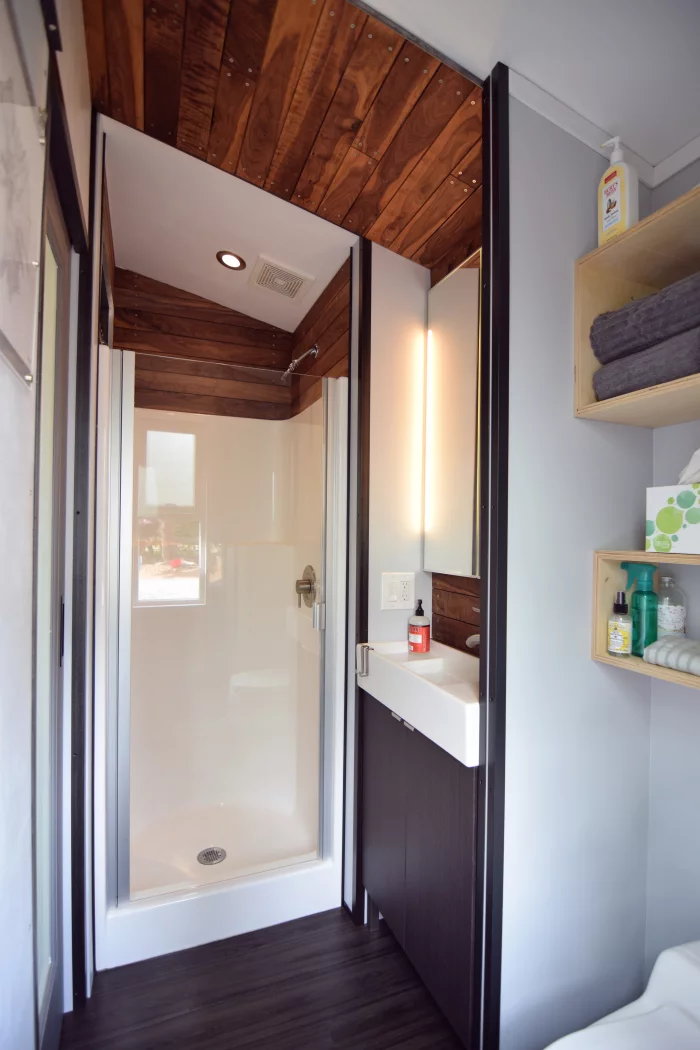 The bathroom includes a shower, sink, and composting toilet