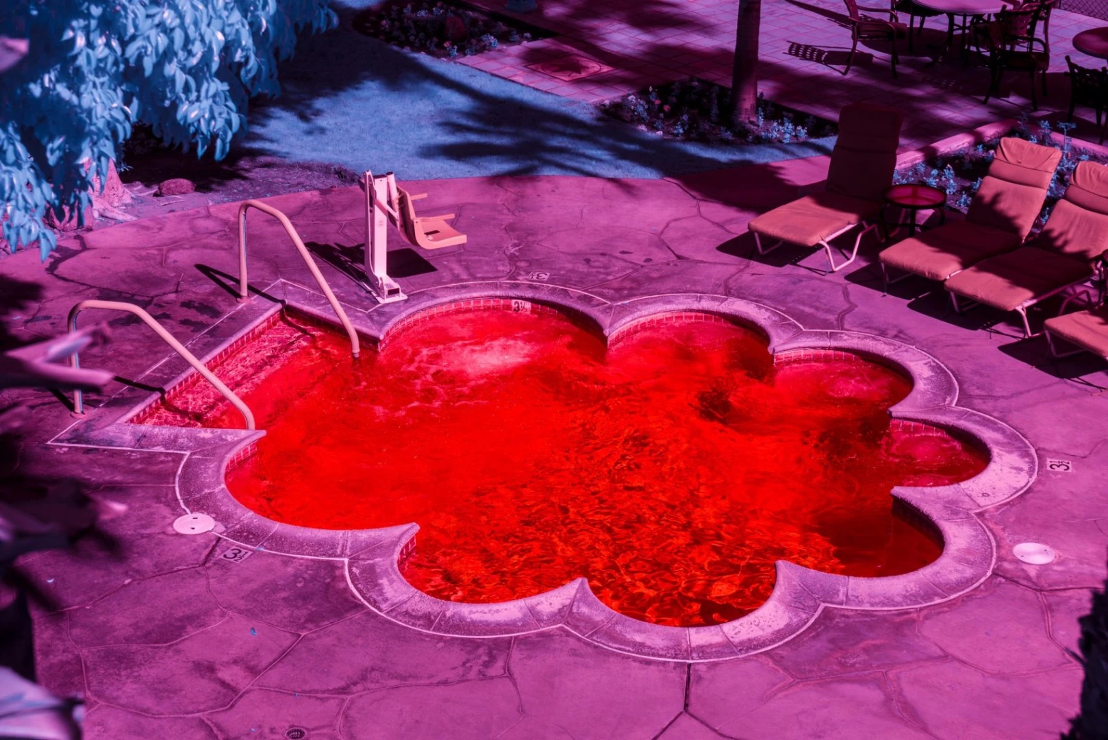 Kate Ballis’ series Infra Realism is an extreme, stylized take on the style contrasting images of classic mid-century Palm Springs architecture with jarringly sharp and disorientating infrared purples and reds