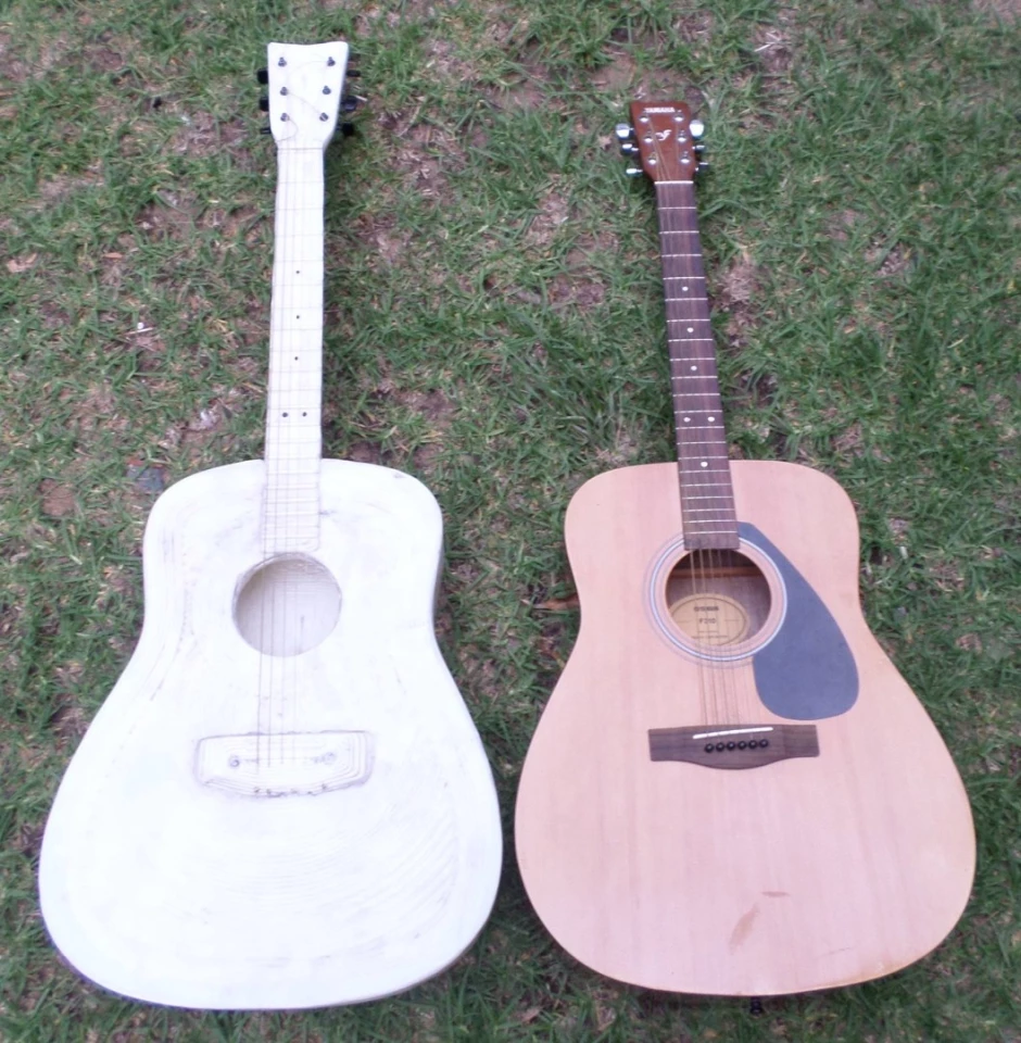The 3D-printed guitar next to the instrument used as a template