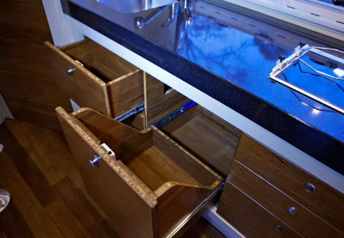 The kitchen area includes a variety of storage space