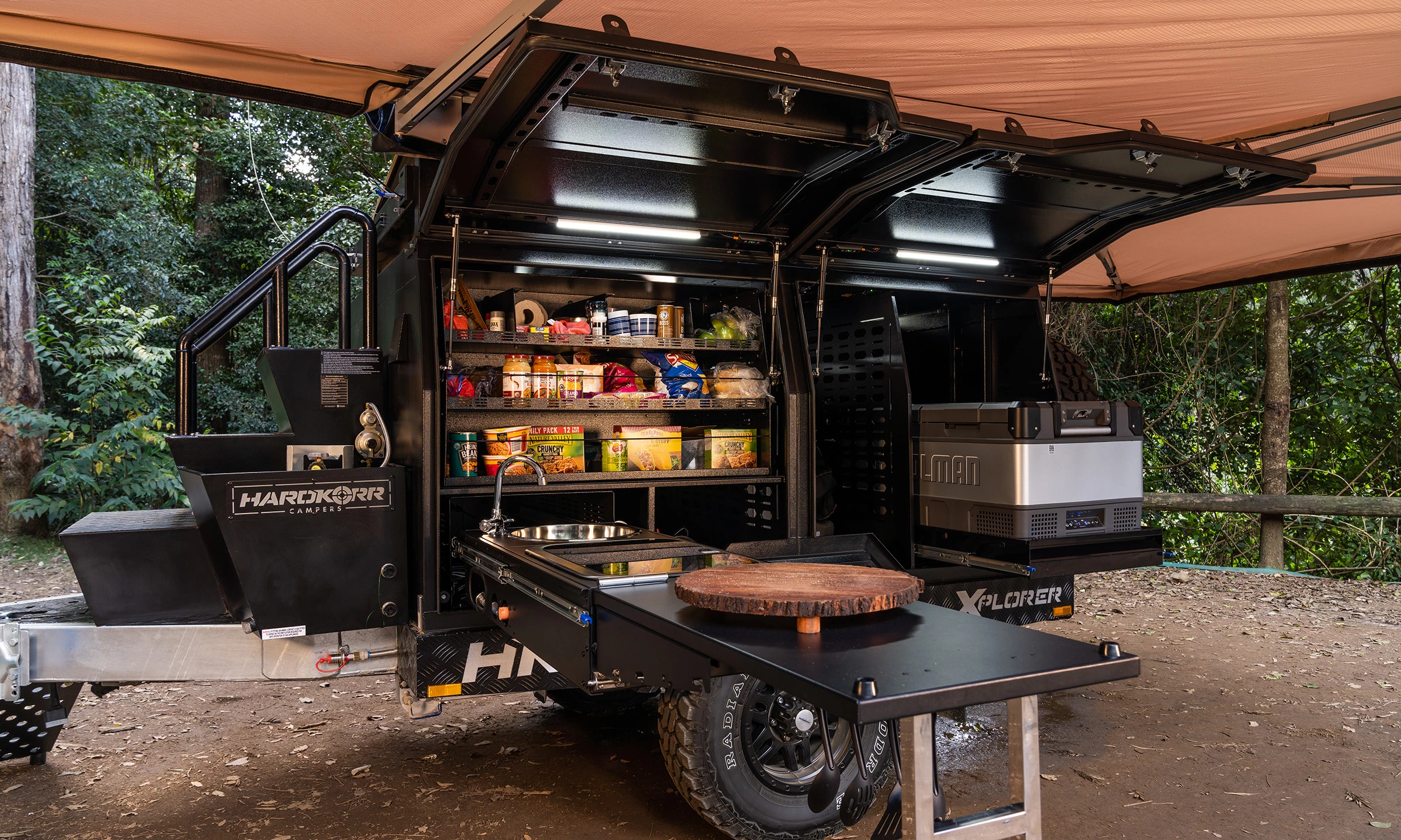 The lefthand side of the trailer is designed to accommodate the available slide-out kitchen, pantry and fridge/freezer
