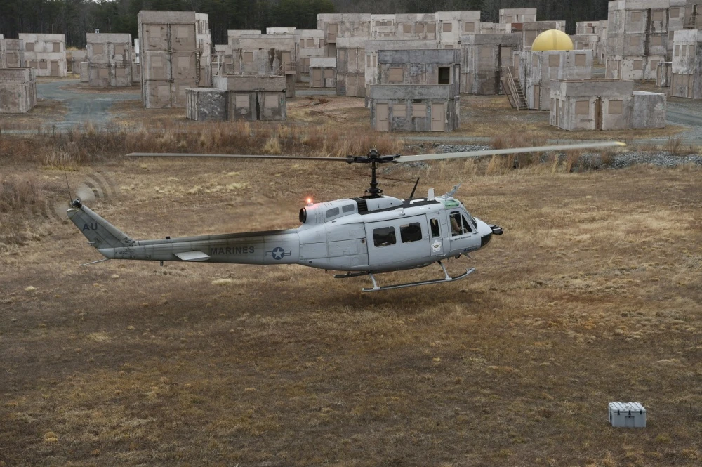 A UH-1 Huey equipped with an AACUS autonomy kit makes an approach for landing during final testing at Marine Corps Base Quantico