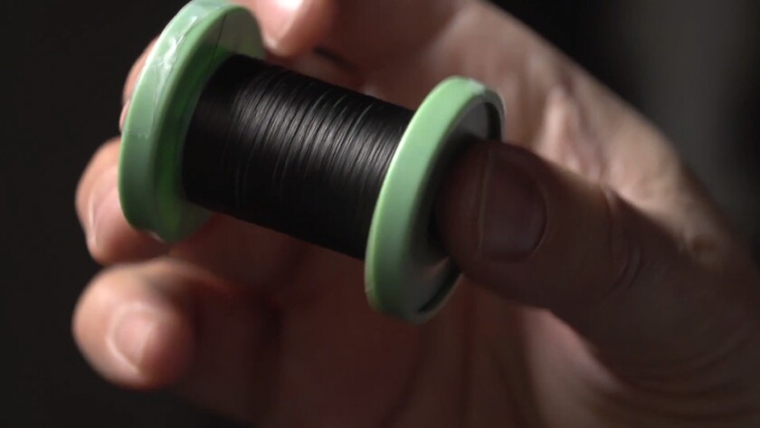A spool with around 50 m (164 ft) of the new threadlike carbon nanotube fiber