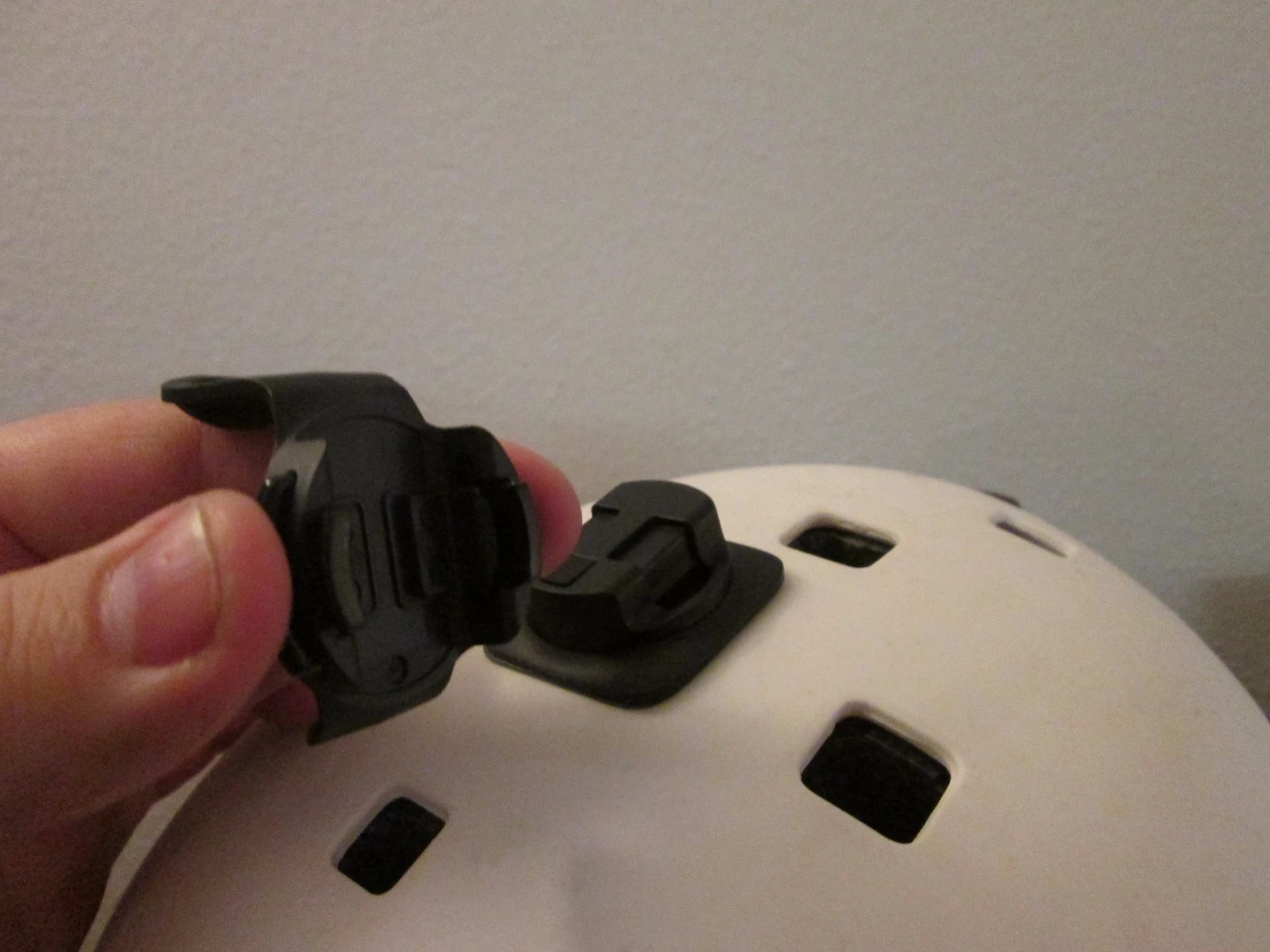 The Polaroid Cube showing the detachable clip and helmet mount
