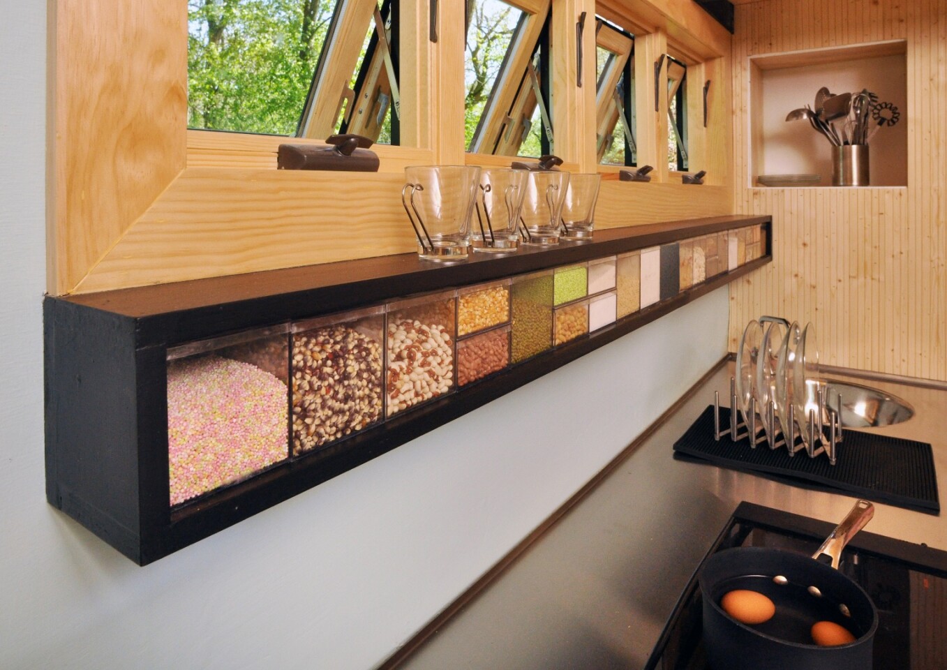 The kitchen also includes fridge, freezer, microwave, and a hidden pantry wall