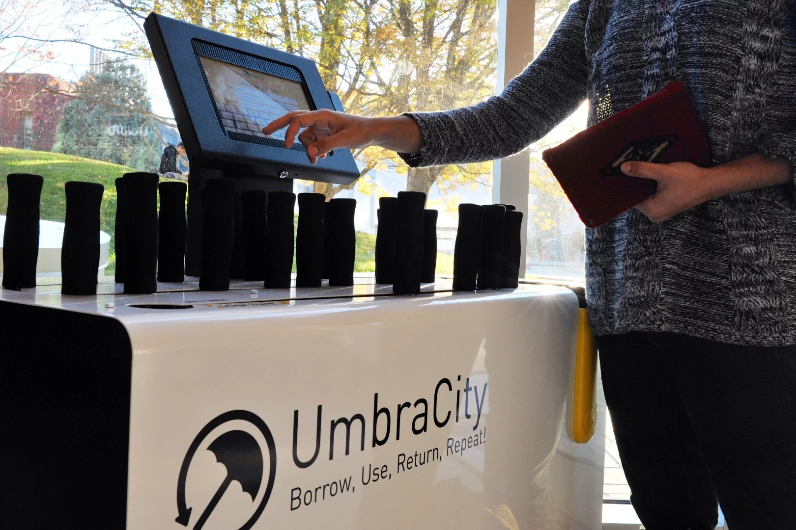 Individuals must first sign up for membership at one of the kiosks, after which they can swipe their membership card at a kiosk to sign out one of the umbrellas