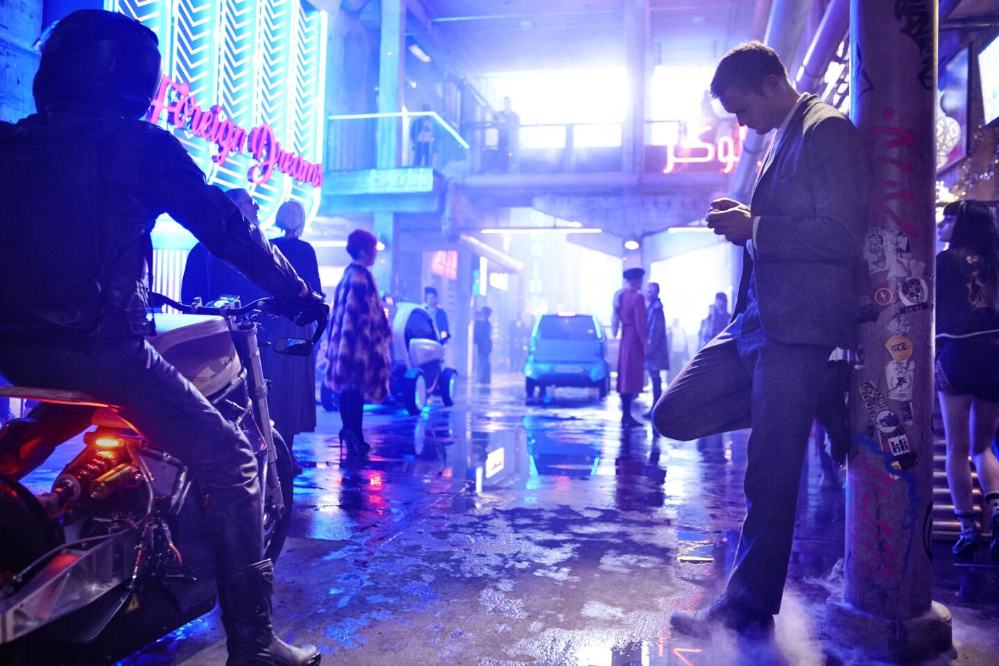 The wet, neon-covered city streets directly recall Blade Runner in Duncan Jones' upcoming Mute
