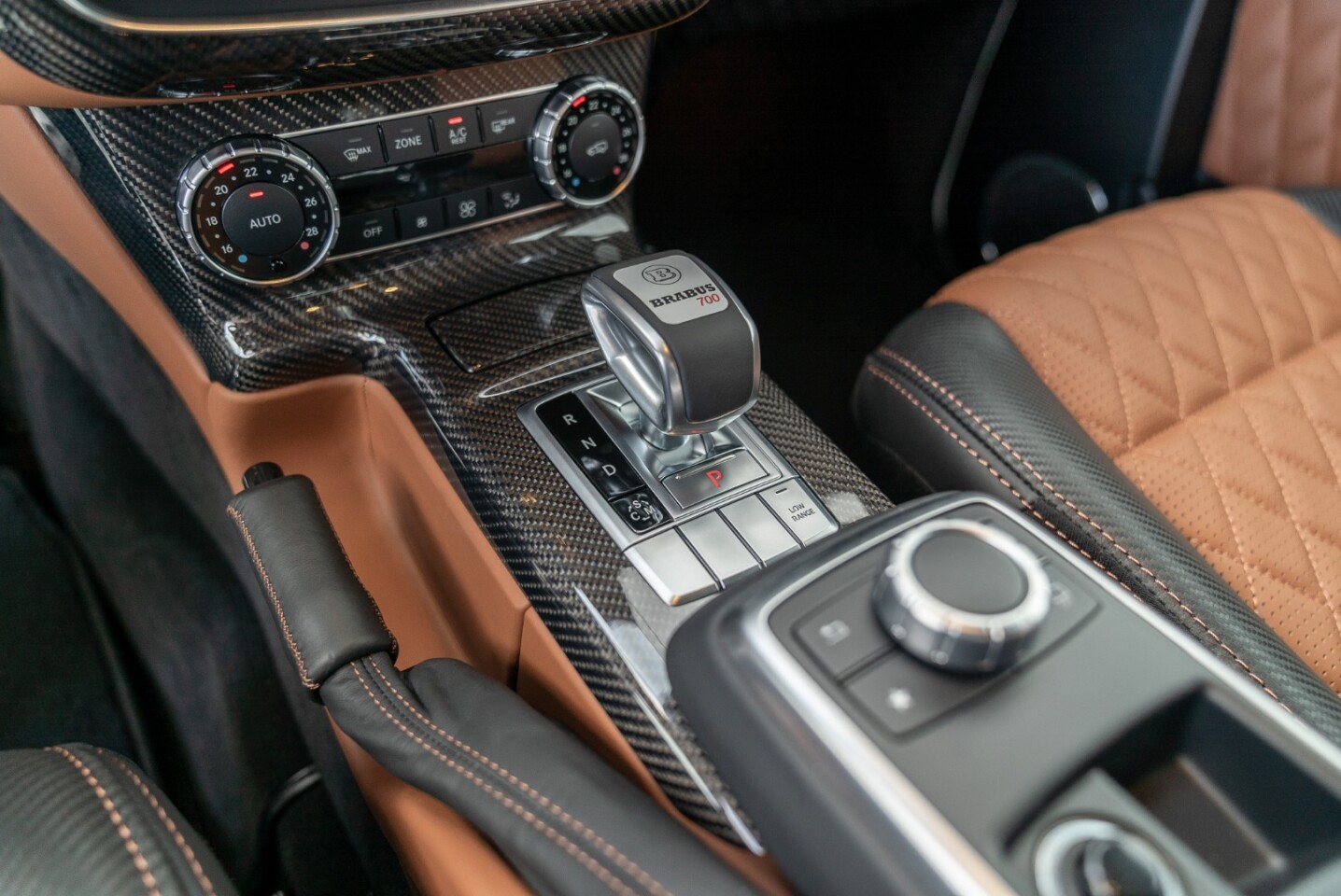 The interior is a two-tone black/brown leather job with carbon accents