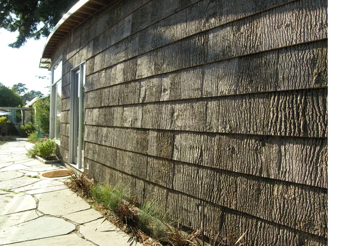 The home's lower walls are clad in poplar bark, a waste product from the furniture industry of North Carolina