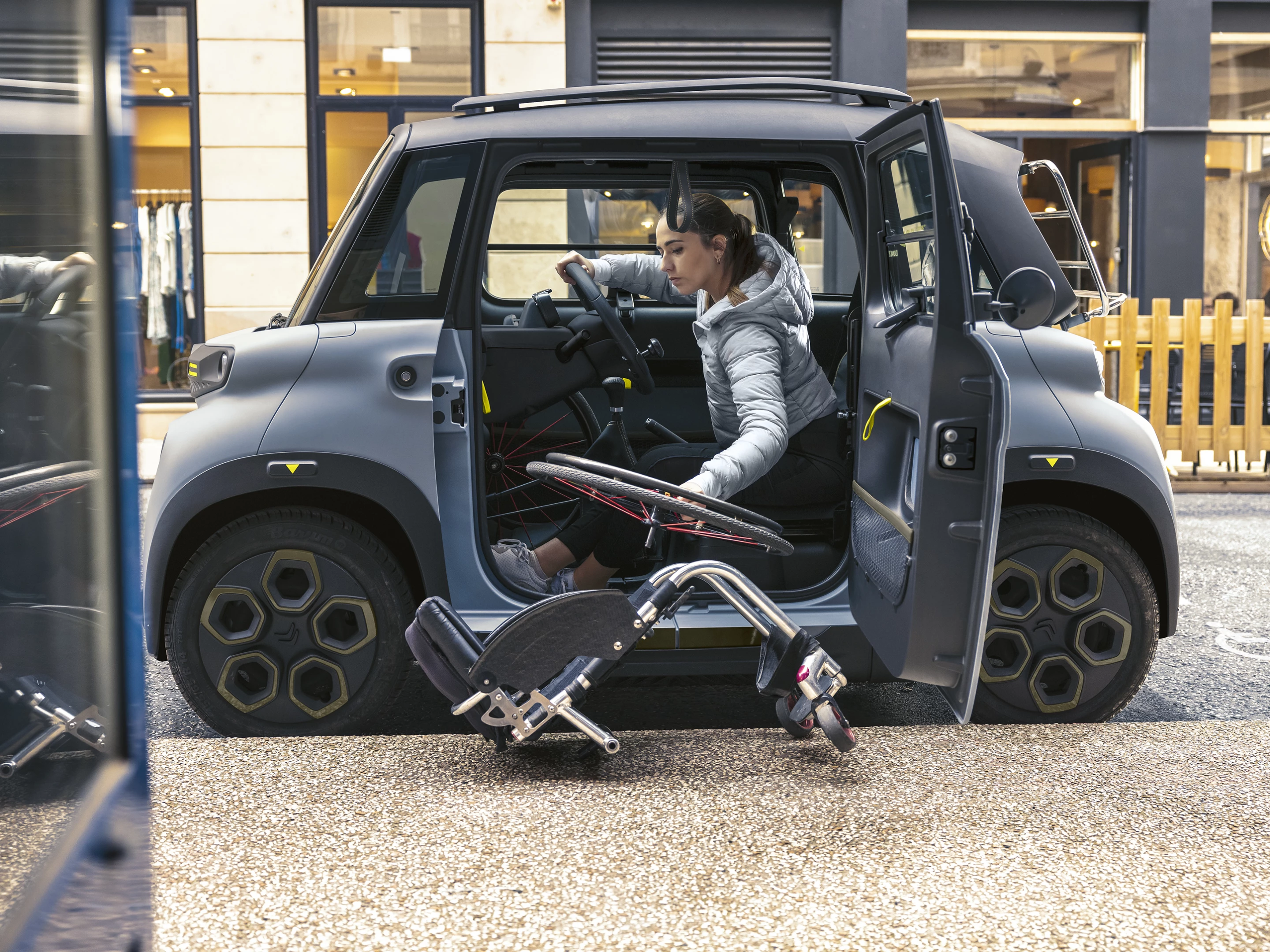 Modifications to the Ami electric city car include improved access at the driver door, cabin adaptations to allow for internal storage of a dismantled wheelchair, and hand-level braking/acceleration controls