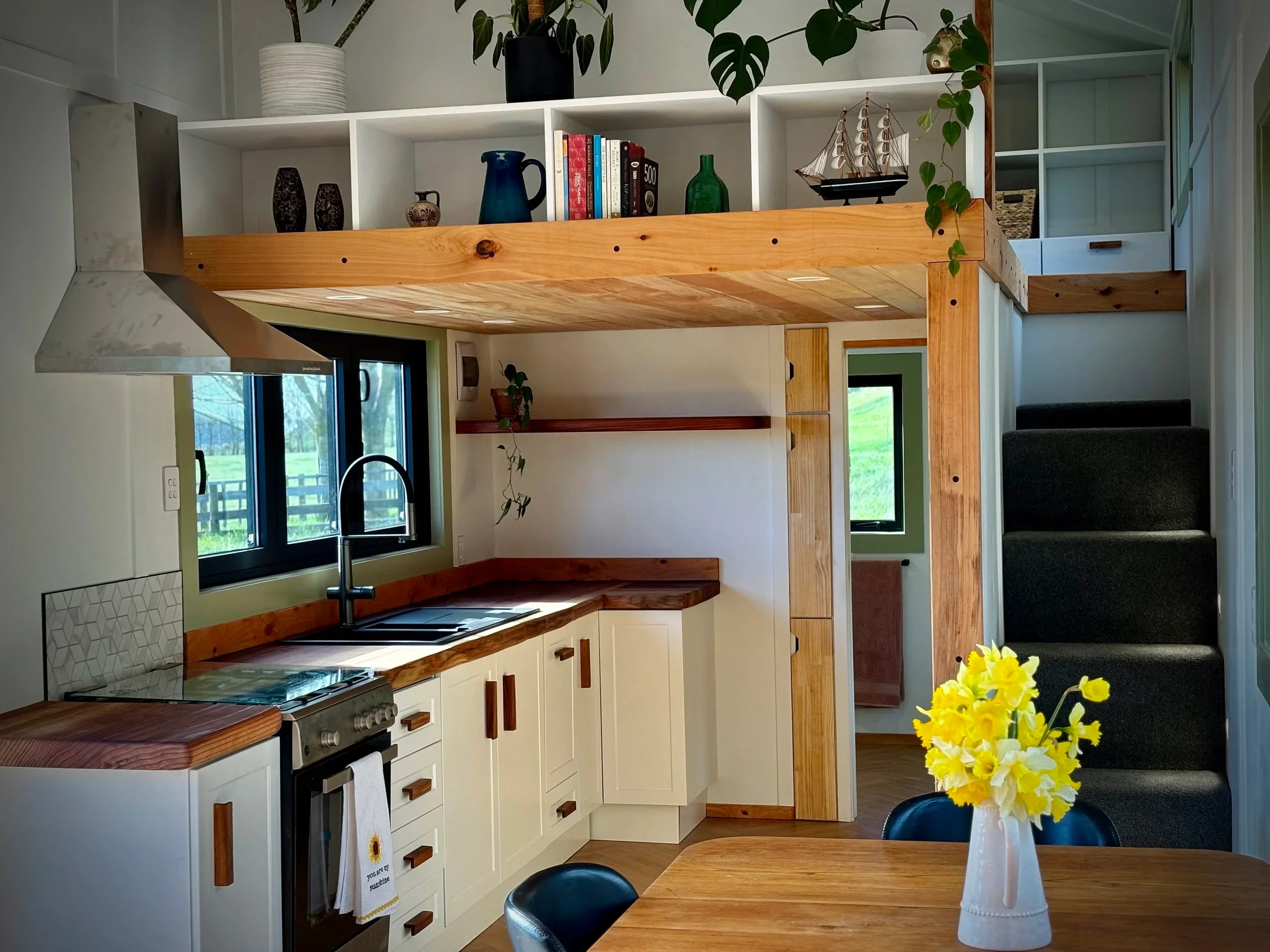 The Redwood's kitchen includes a sink, an oven and four-burner propane-powered stove, and a fridge/freezer