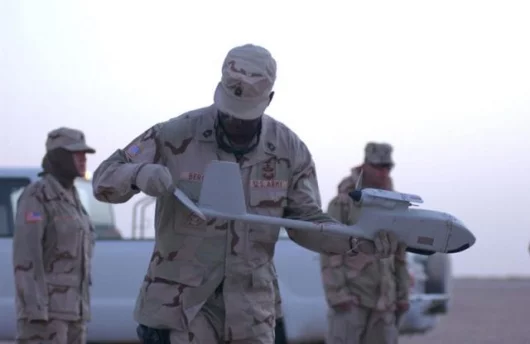 Sgt. 1st Class Austin Bergan, an intelligence analyst from the 3rd Infantry Division, assembles the Raven unmanned aerial vehicle.