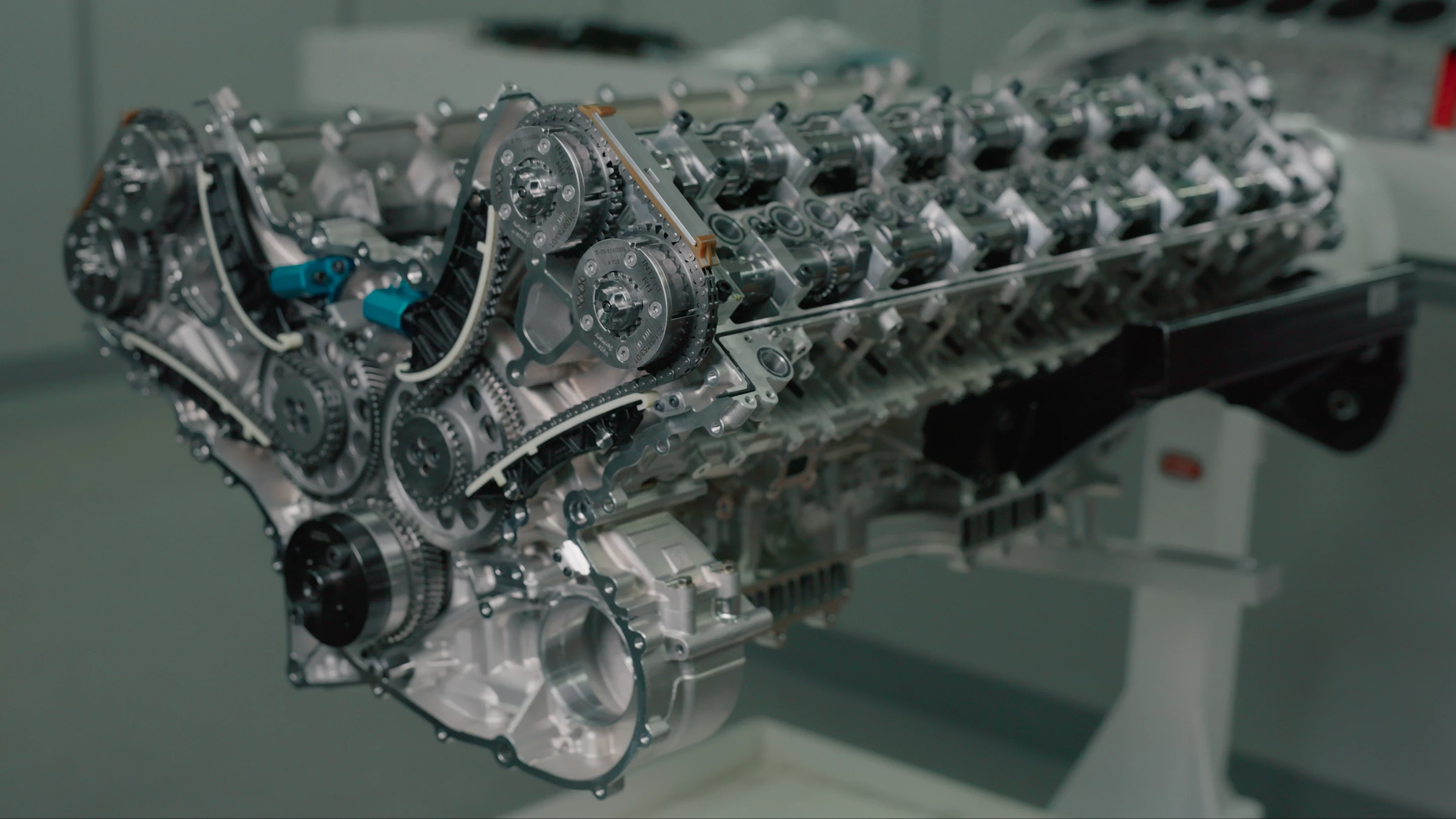 Bugatti's Tourbillon V16 engine, gear driven cams exposed, is much longer than it appears