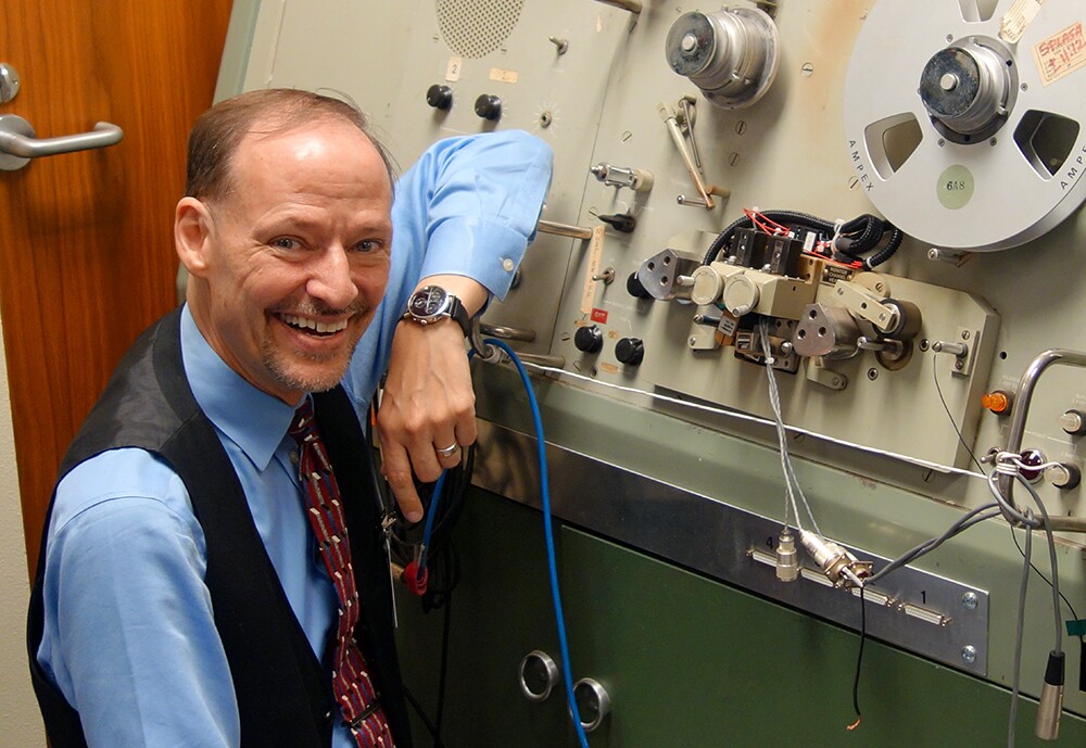 Dr. John H.L. Hansen stands next to the SoundScriber, the only device that could play the analog recordings of thousands of hours of communications during NASA’s lunar missions