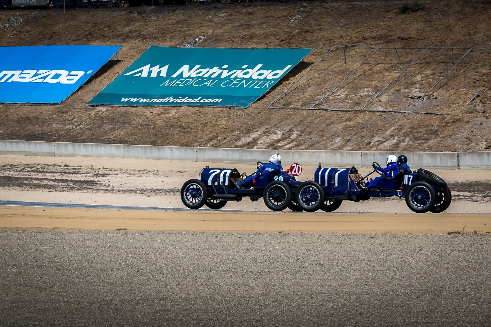 Two-man racing was once a thing, as witnessed by this 1916 National AC chasing down a 1911 National 40