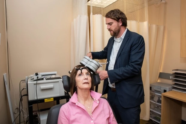 Nolan Williams, senior author on the new study, demonstrating the SAINT treatment with Deirdre Lehman, a subject from the preliminary trial