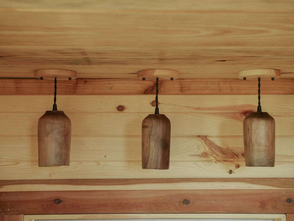 The Honey on the Rock's interior has decorative touches like wooden lamps, and exposed soldered copper water piping