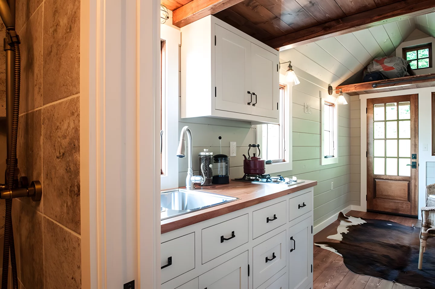 The Ynez's kitchen includes a two-burner propane-powered stove, a fridge/freezer, and a sink