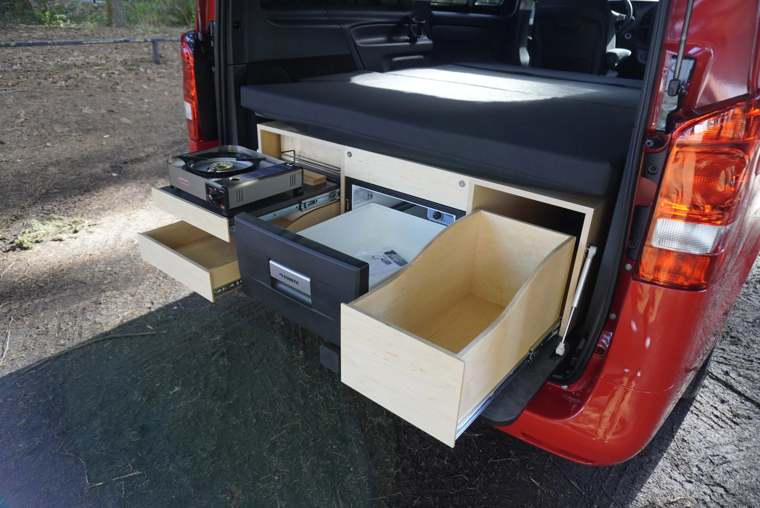 The compact kitchen doesn't have a sink, but Caravan Outfitter offers an optional swing-out indoor/outdoor sink unit in front of the rear bench