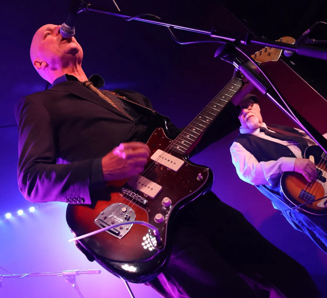 The author (left), with his battered and beloved Mexican Jazzmaster, performing with Radio Radio