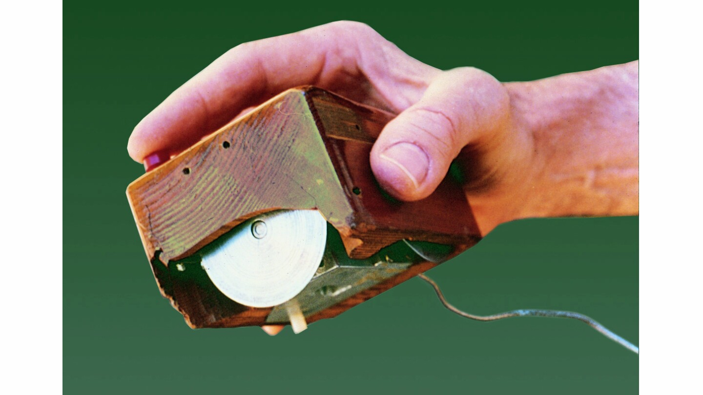 The first mouse was a wooden shell with two metal wheels (Image: SRI International)
