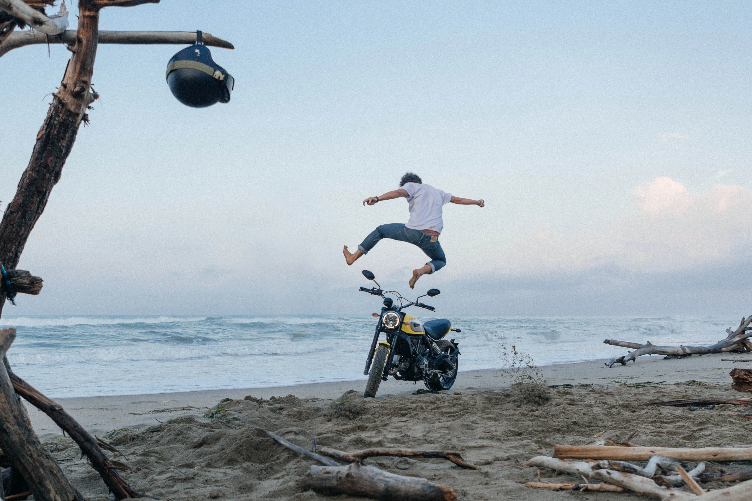 Man jumps over Ducati Scrambler at the beach