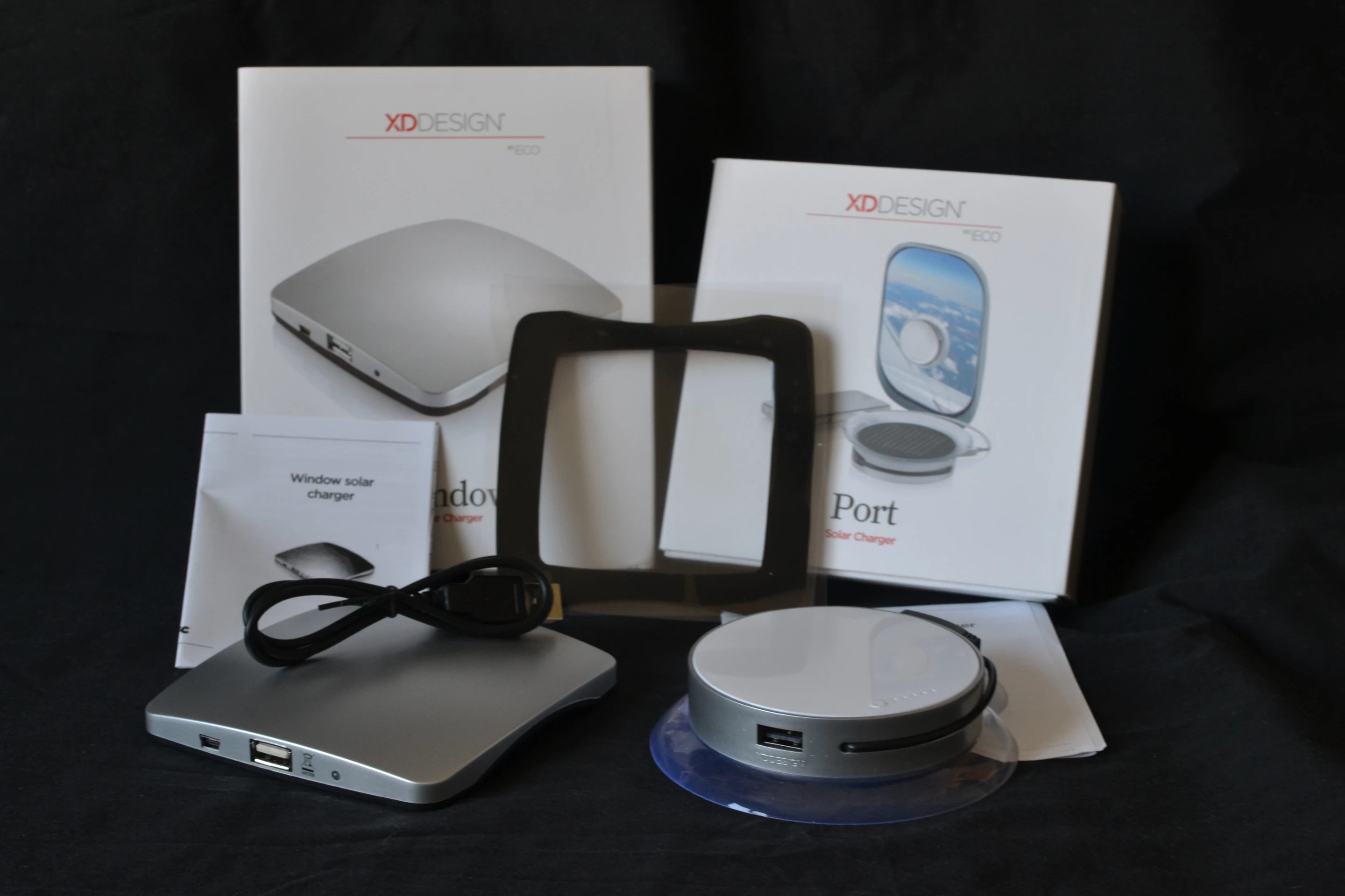 Box shots of the Window and Port solar chargers from XD Design