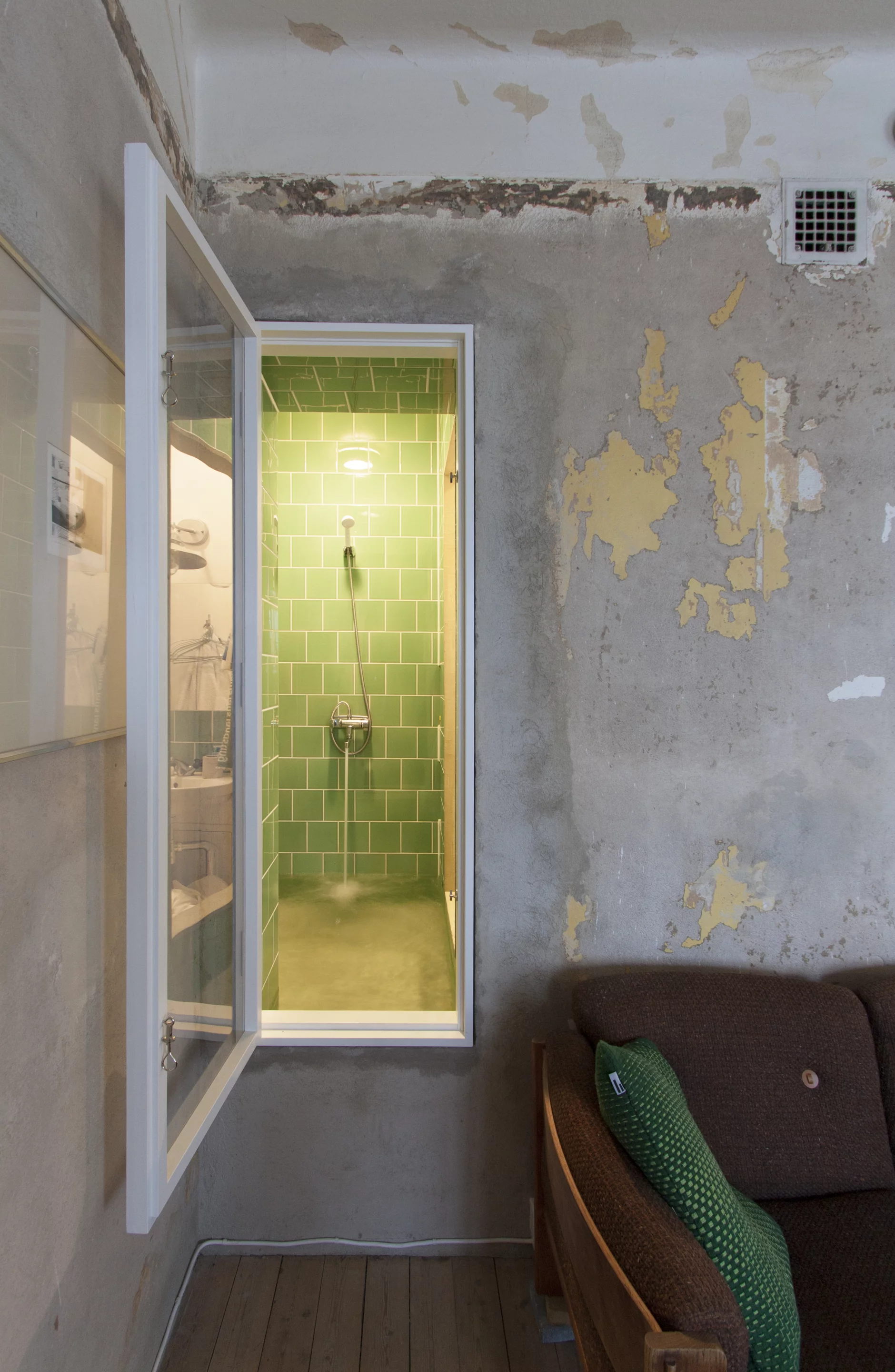 The bathroom shares an internal window with the living room, which also has a curtain for privacy