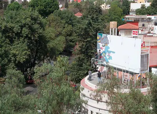 The Billboard House is a simple home built onto the back of a billboard in Mexico City to temporarily house an artist while she works on a new hand-painted advertisement