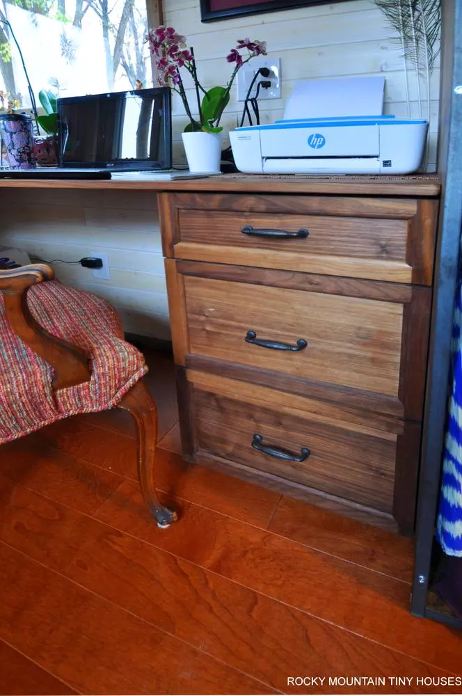 The Red Mountain 34' Tiny House includes a small home office nook