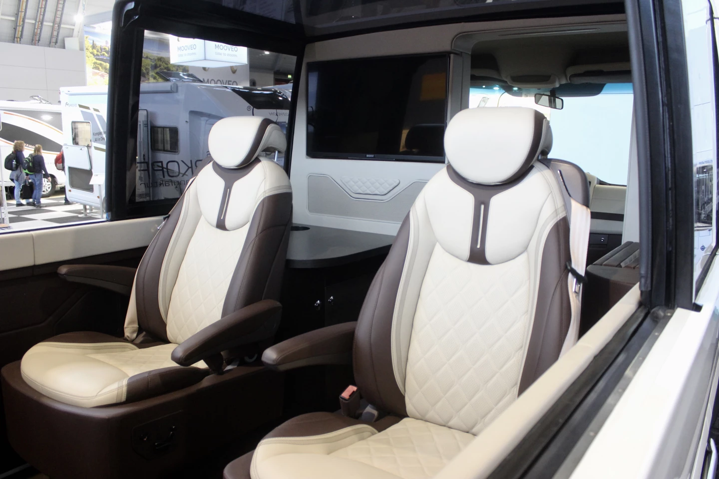 Inside, leather seats facing each other and flat-screen TVs create a luxurious atmosphere