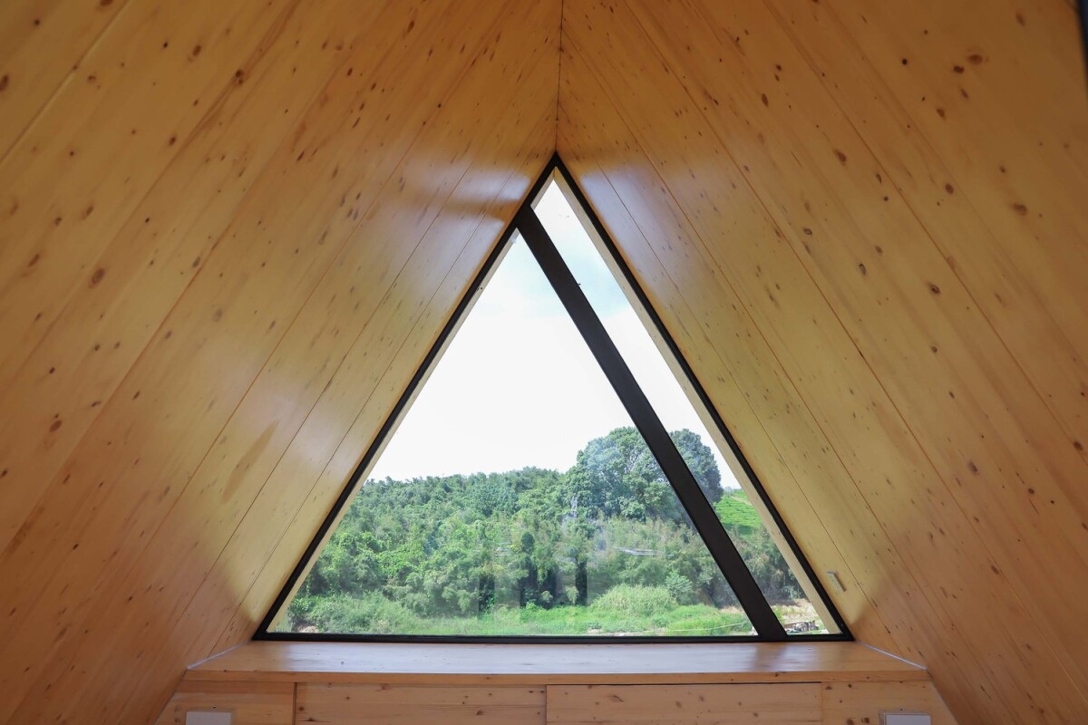 Beautiful large triangular glass window looks out across the Chinese countryside