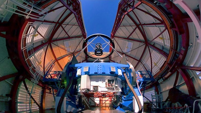 The Magellan Clay telescope under its dome in Chile. The adaptive secondary mirror is floated on a magnetic field inside the cage seen in the upper part of the figure (Photo: University of Arizona)