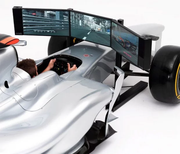 Realistic steering feedback is provided to the removable steering wheel by a high-use force feedback unit with industrial rollers and motors