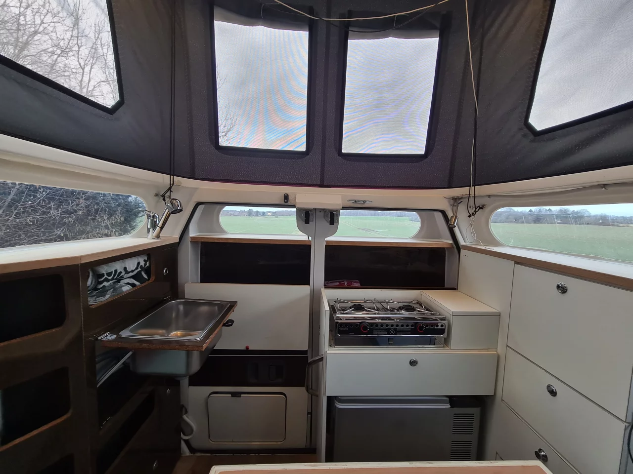 Cabineer kitchen with stove and sink ready to work