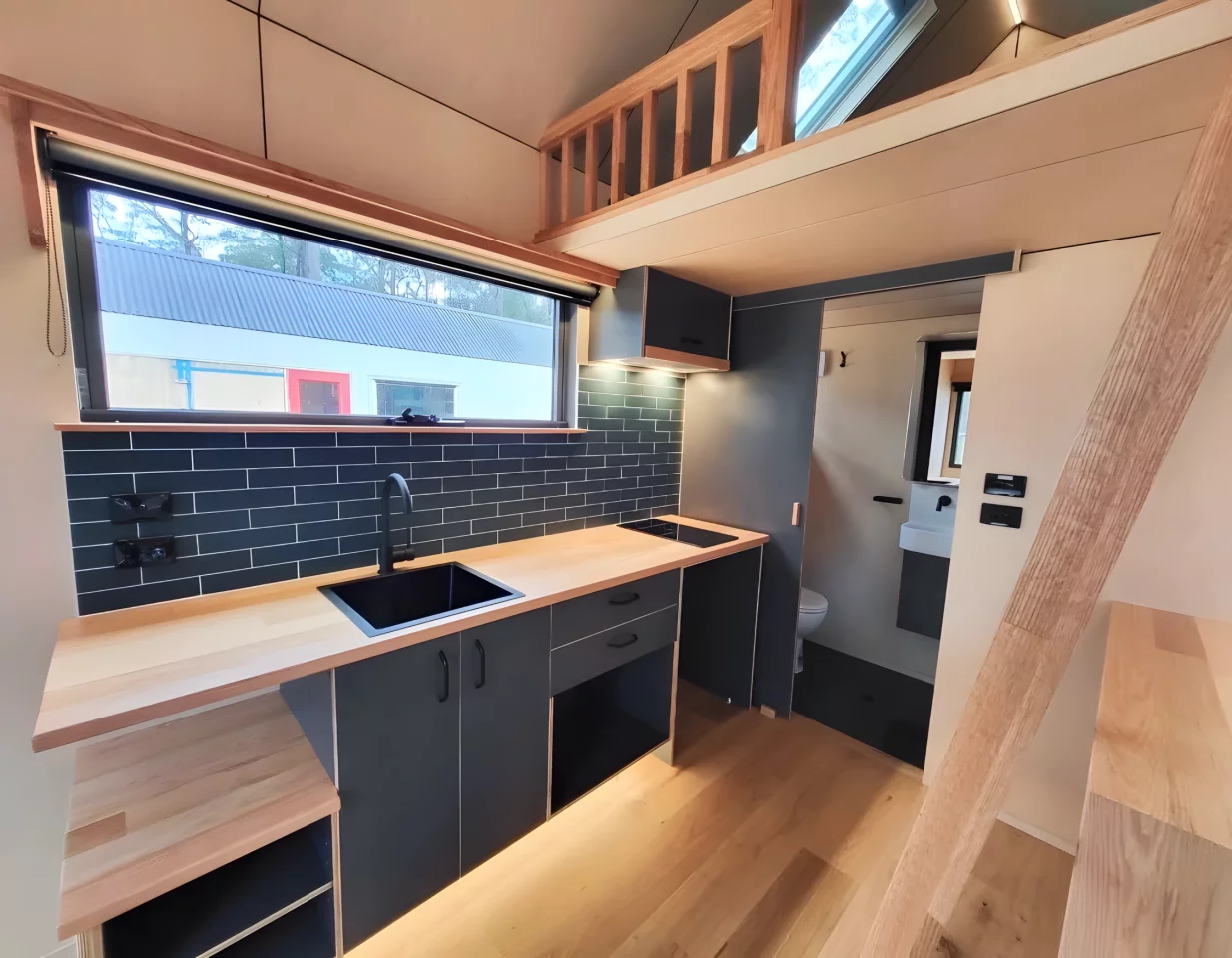 The Gunyah Modern's kitchen includes an induction cooktop and sink, plus it has space for more appliances to be installed