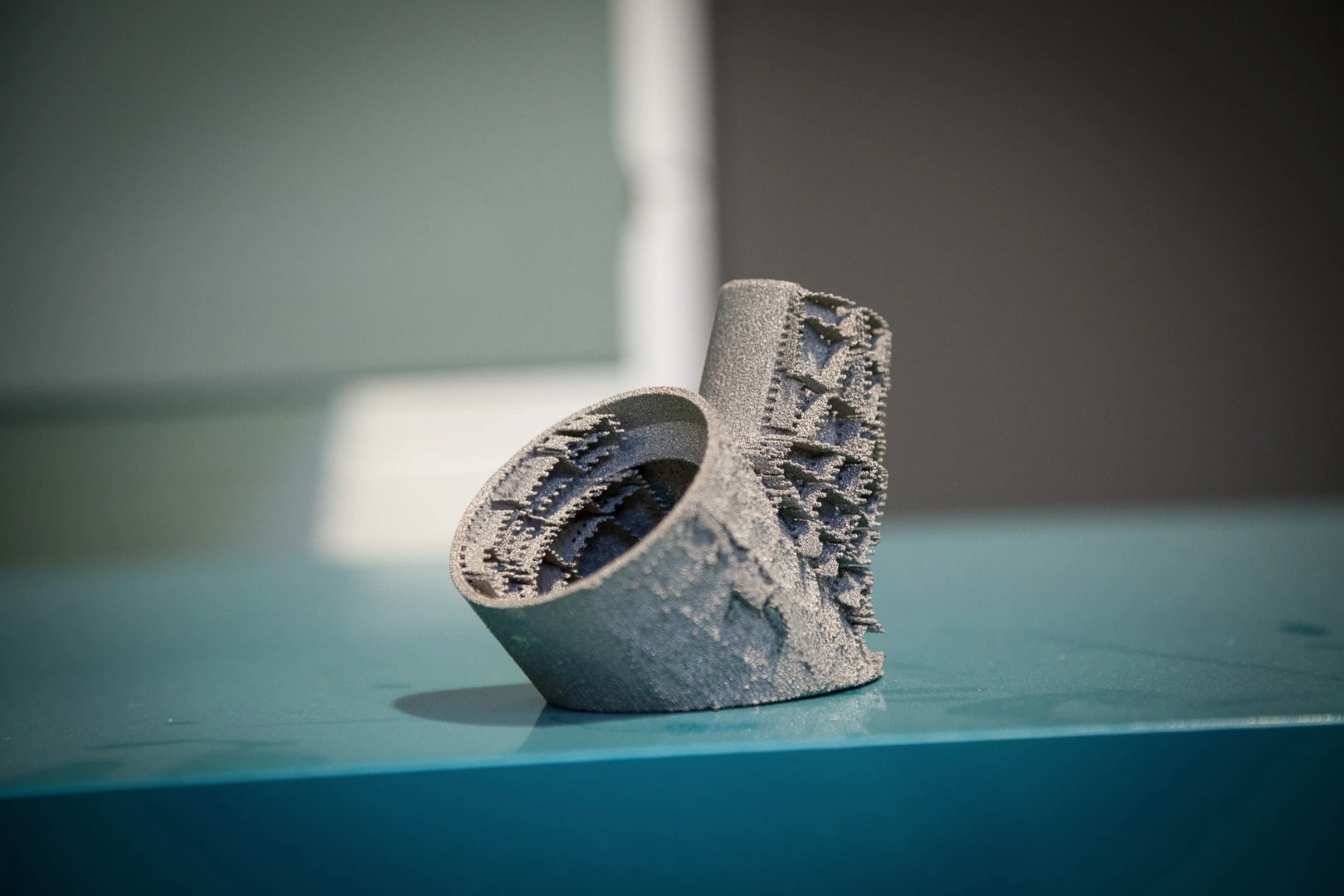 Titanium bicycle frame lug, showing breakable support fins that help to dissipate heat during printing