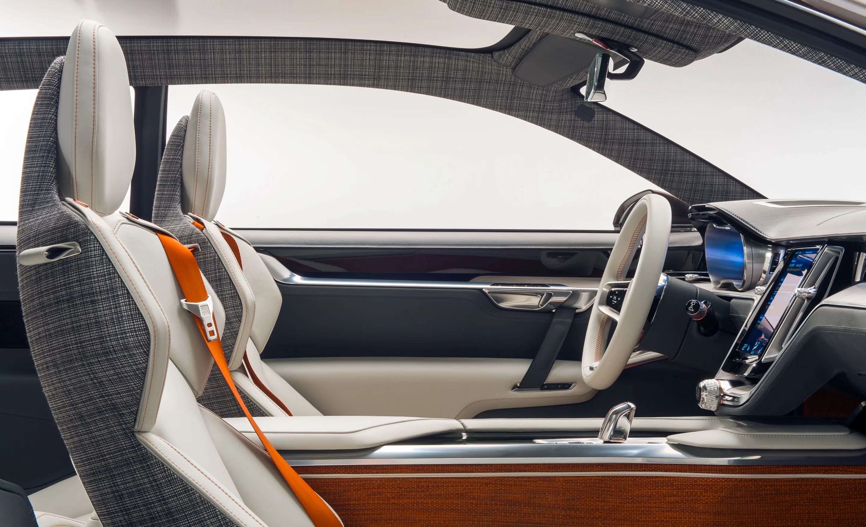 The interior is bright and energetic thanks to a full glass roof, light colored leather seats, wood inlays and assorted retro design touches