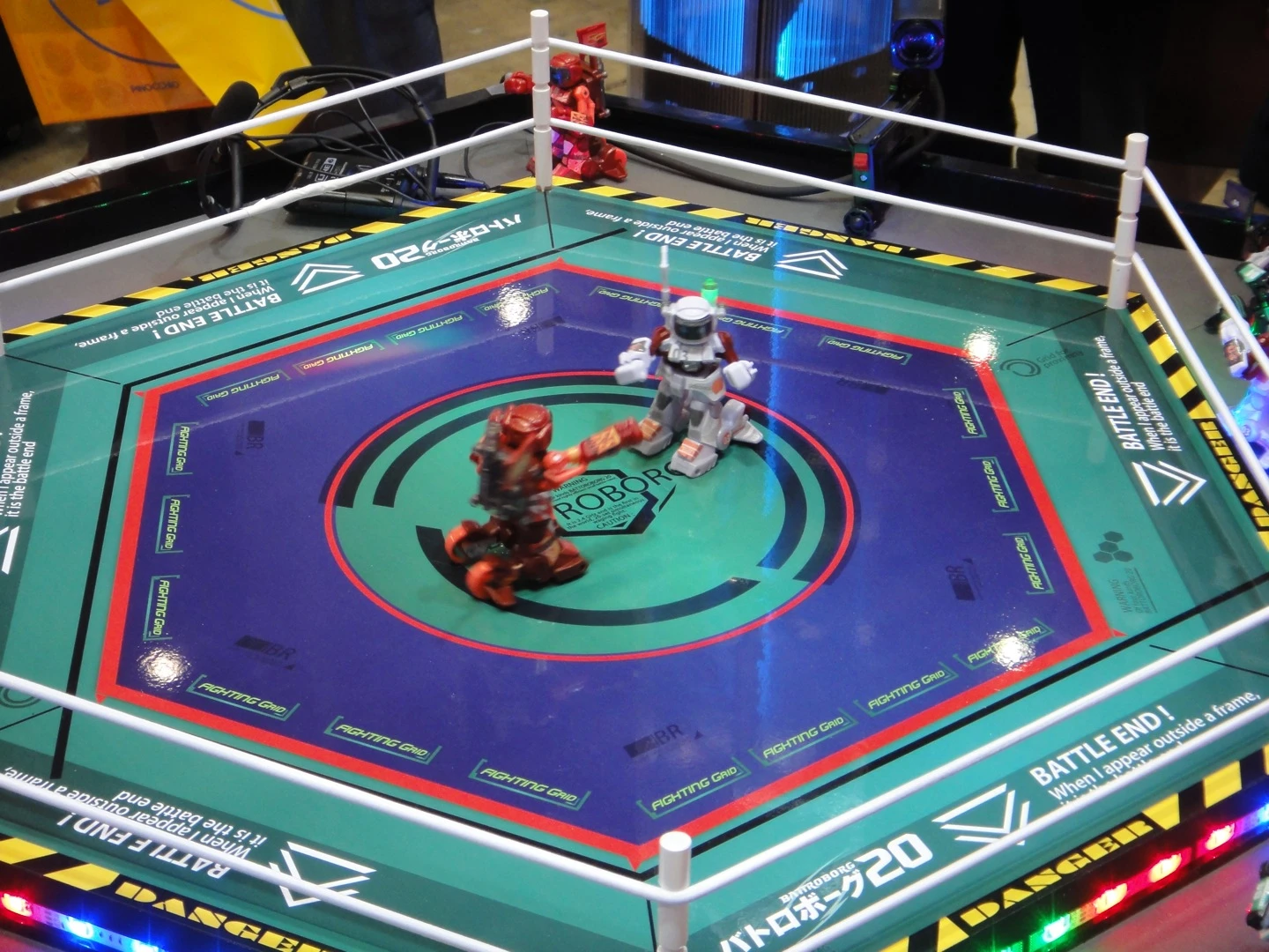 The robots fight within a hexagonal ring