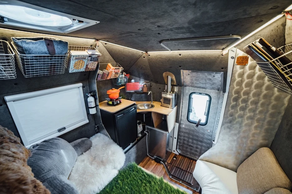 Kimbo creates a stylish, inviting space with brushed fabric walls, bare aluminum and a teak-floor entry