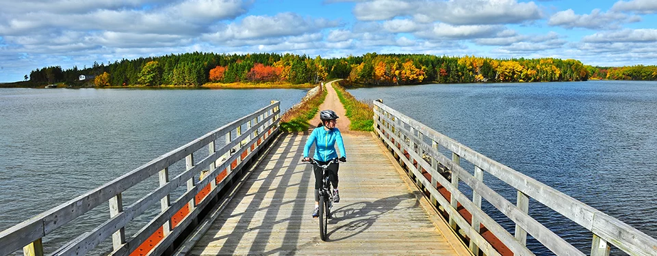 Bicyclist crossing a bridge on The Great Trail in Canada