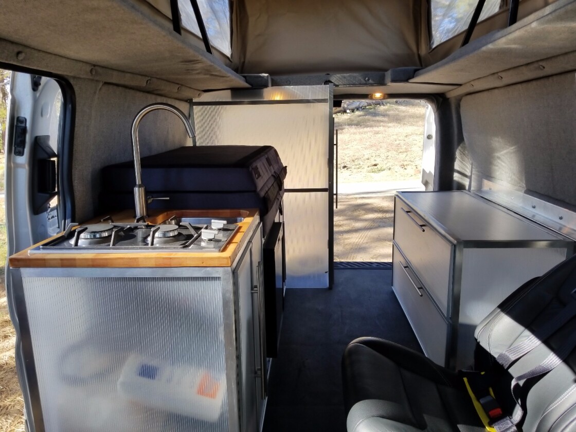 The passenger side includes the kitchen, storage cabinet and toilet room